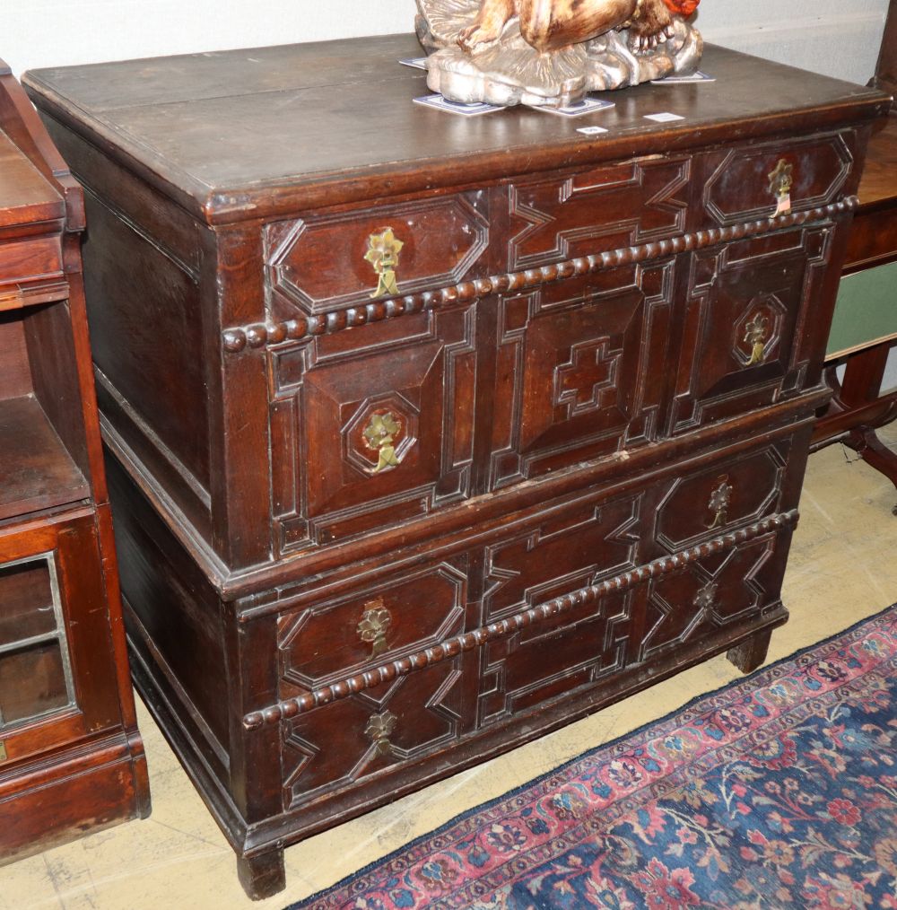 A 17th century style geometric moulded oak two part chest, W.100cm, D.58cm, H.96cm